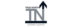 Logo for True North Scenic Flights featuring the letters TN in bold gray and black, with an arrow pointing upwards, symbolizing flight or north. The text TRUE NORTH is above and SCENIC FLIGHTS below.